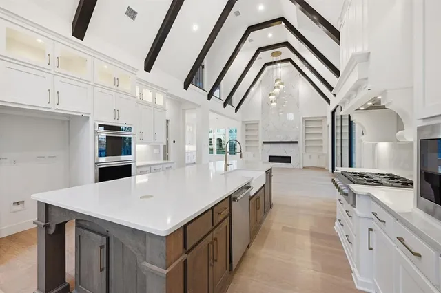 a large white kitchen with a large window