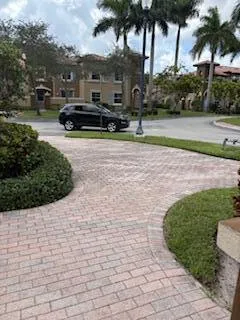a view of a street with a building and trees in the background