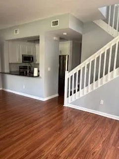 a view of a living room with wooden floor