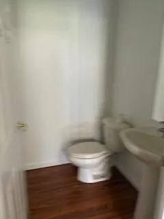 a white toilet sitting next to a white sink