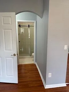 a view of a hallway with wooden floor