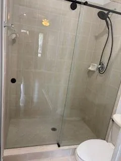 a bathroom with a shower and toilet