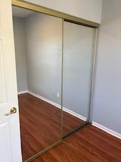 a view of a room with wooden floor