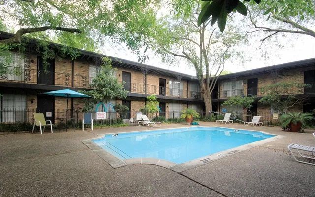 a view of a house with pool and sitting area