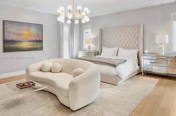 a bathroom with a bathtub a sink a window and a mirror