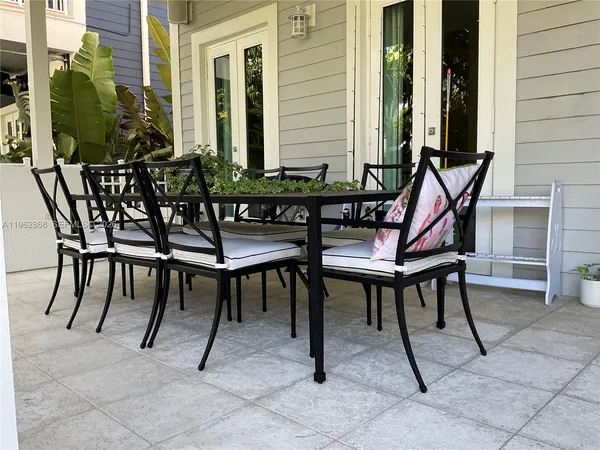 a view of a patio with a table and chairs