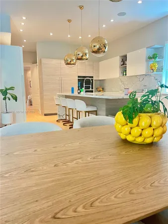 a view of an empty room and kitchen view