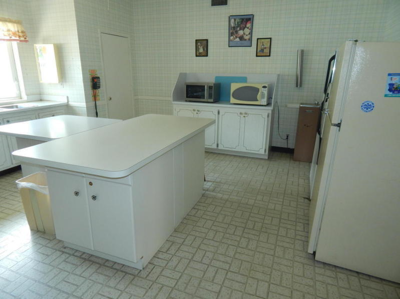 500 Village Green Circle West, Unit 107 Palm Springs, FL 33461 - Photo 18 of 24 Clubhouse Kitchen