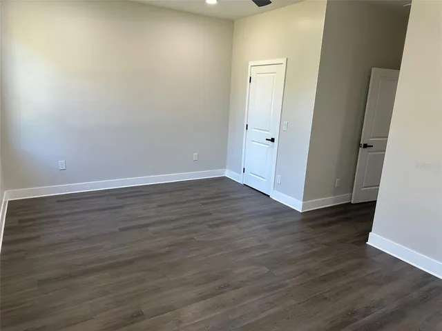 a view of a room with wooden floor