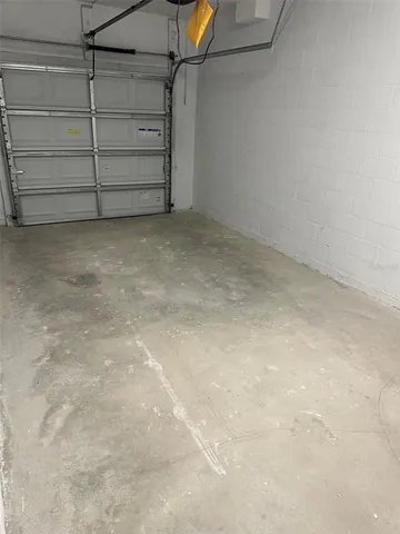 an empty room with wooden floor closet and windows