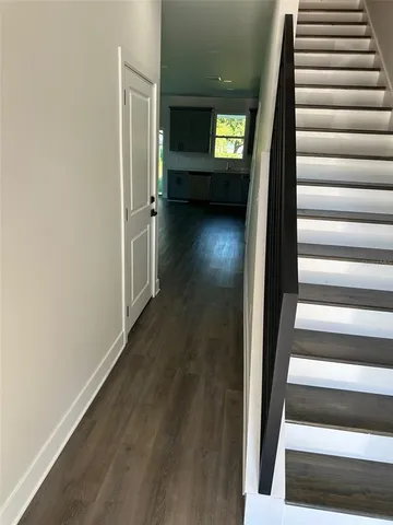 a kitchen with stainless steel appliances a refrigerator and wooden floor