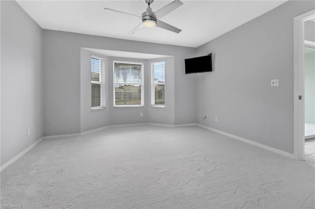 875 New Waterford Drive, Unit T201 Naples, FL 34104 - Photo 11 of 25 a view of an empty room with a window
