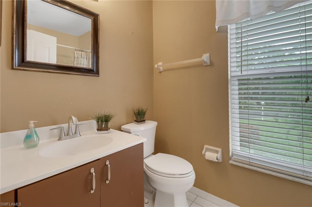 875 New Waterford Drive, Unit T201 Naples, FL 34104 - Photo 17 of 25 a bathroom with a sink mirror and toilet
