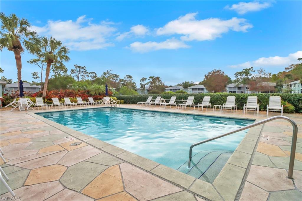 875 New Waterford Drive, Unit T201 Naples, FL 34104 - Photo 22 of 25 a view of swimming pool with outdoor seating and lake view