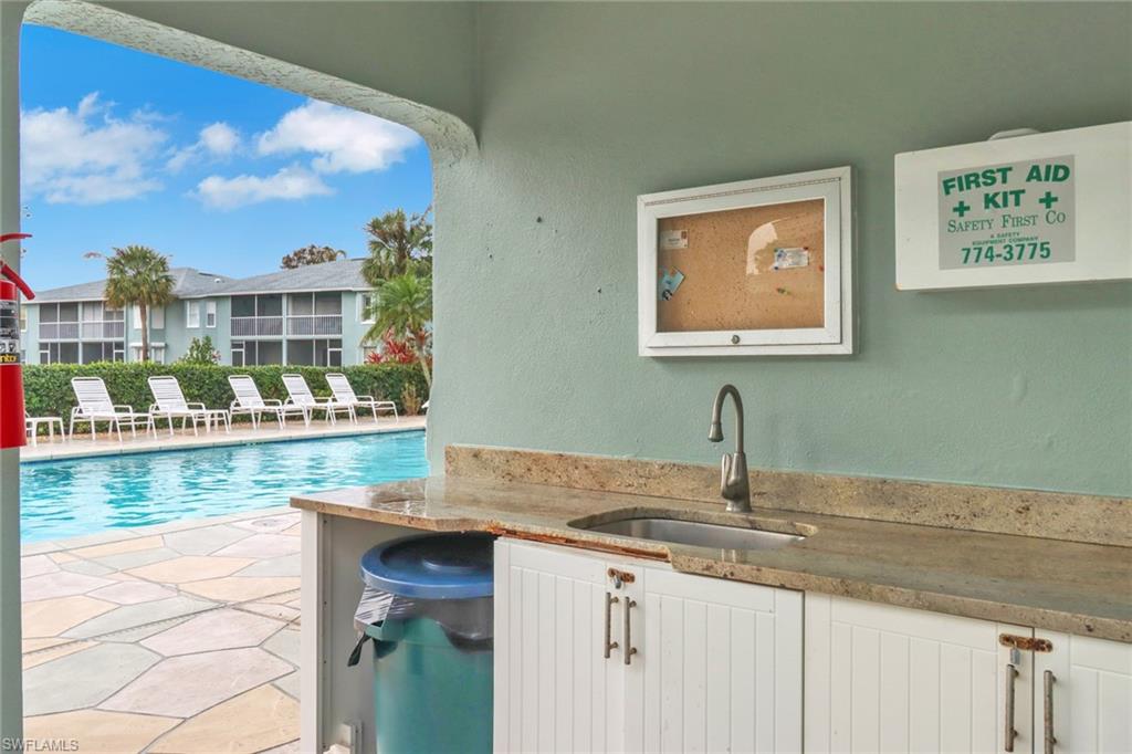 875 New Waterford Drive, Unit T201 Naples, FL 34104 - Photo 23 of 25 a bathroom with a sink and a mirror