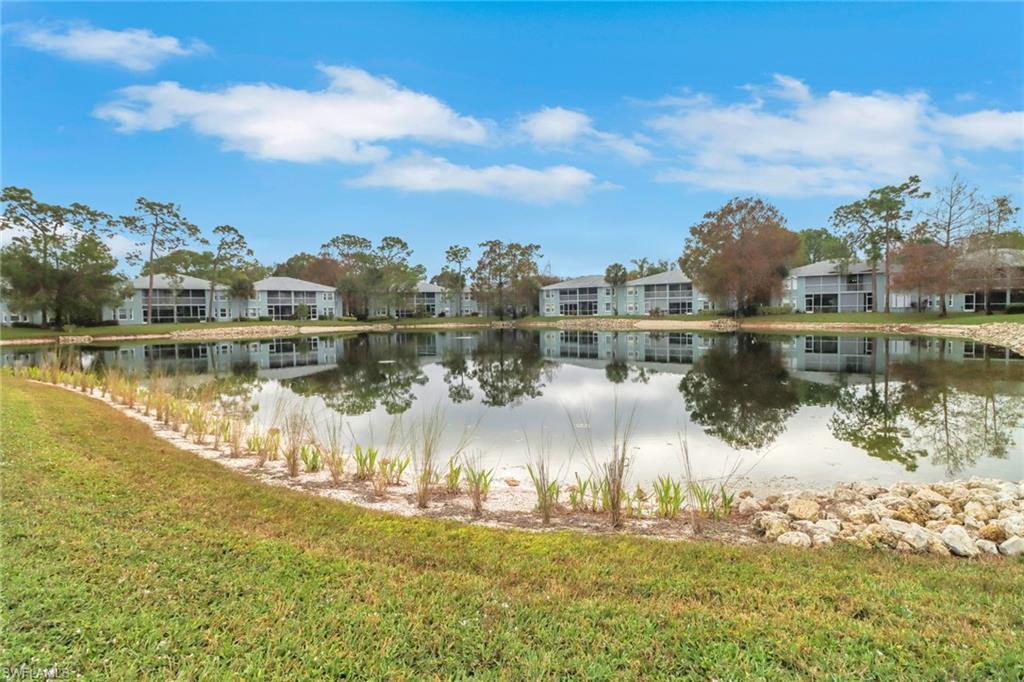 875 New Waterford Drive, Unit T201 Naples, FL 34104 - Photo 24 of 25 a view of a lake with a big yard