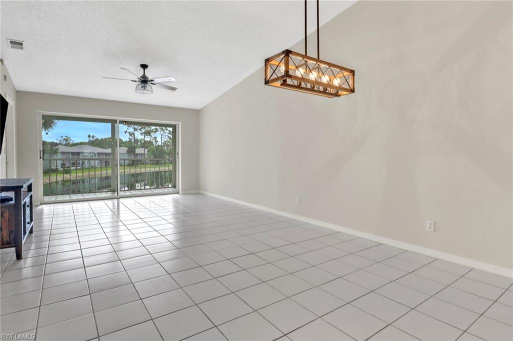875 New Waterford Drive, Unit T201 Naples, FL 34104 - Photo 6 of 25 a view of an empty room with a window