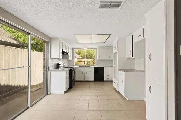 a kitchen with a cabinets and a refrigerator