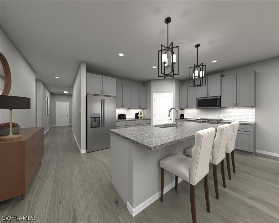 44311 Timberland Terrace Punta Gorda, FL 33982 - Photo 3 of 7 a kitchen with granite countertop a center island stainless steel appliances cabinets and a center
