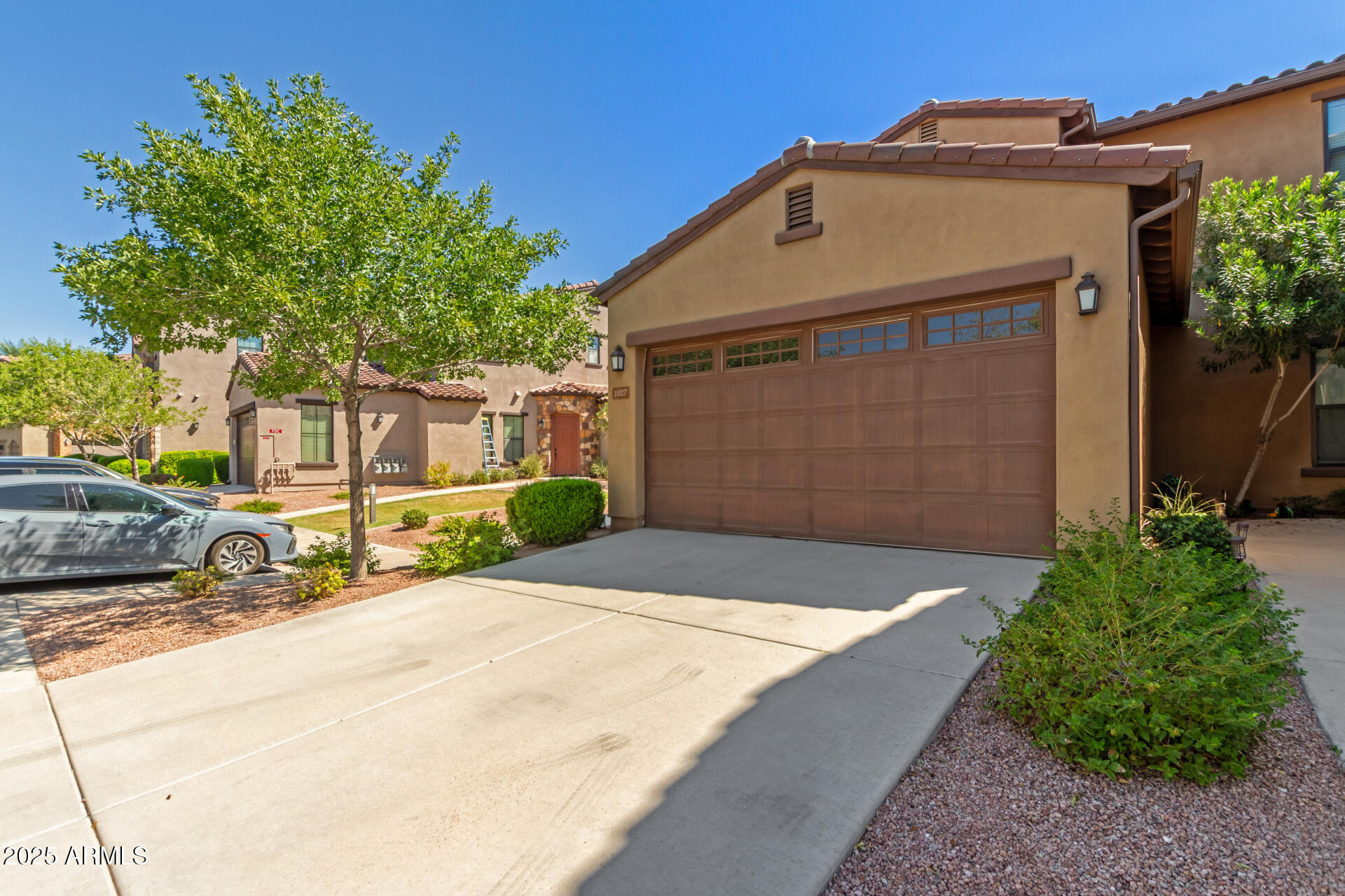 4777 South Fulton Ranch Boulevard, Unit 1027 Chandler, AZ 85248 - Photo 3 of 50 a front view of a house with a yard