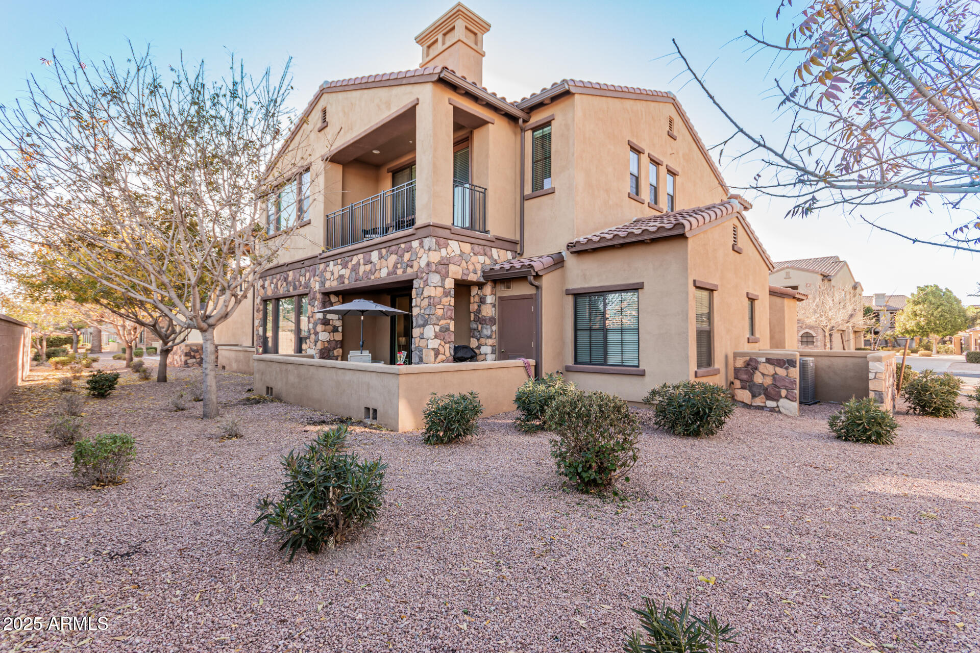 4777 South Fulton Ranch Boulevard, Unit 1027 Chandler, AZ 85248 - Photo 33 of 50 a front view of a house with garden