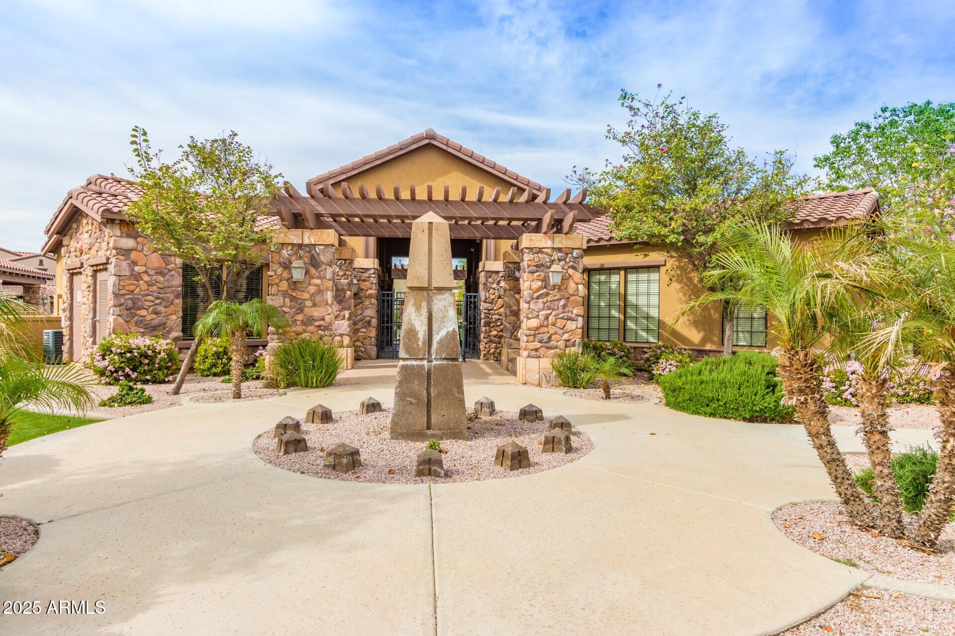 4777 South Fulton Ranch Boulevard, Unit 1027 Chandler, AZ 85248 - Photo 39 of 50 a front view of a house with a yard