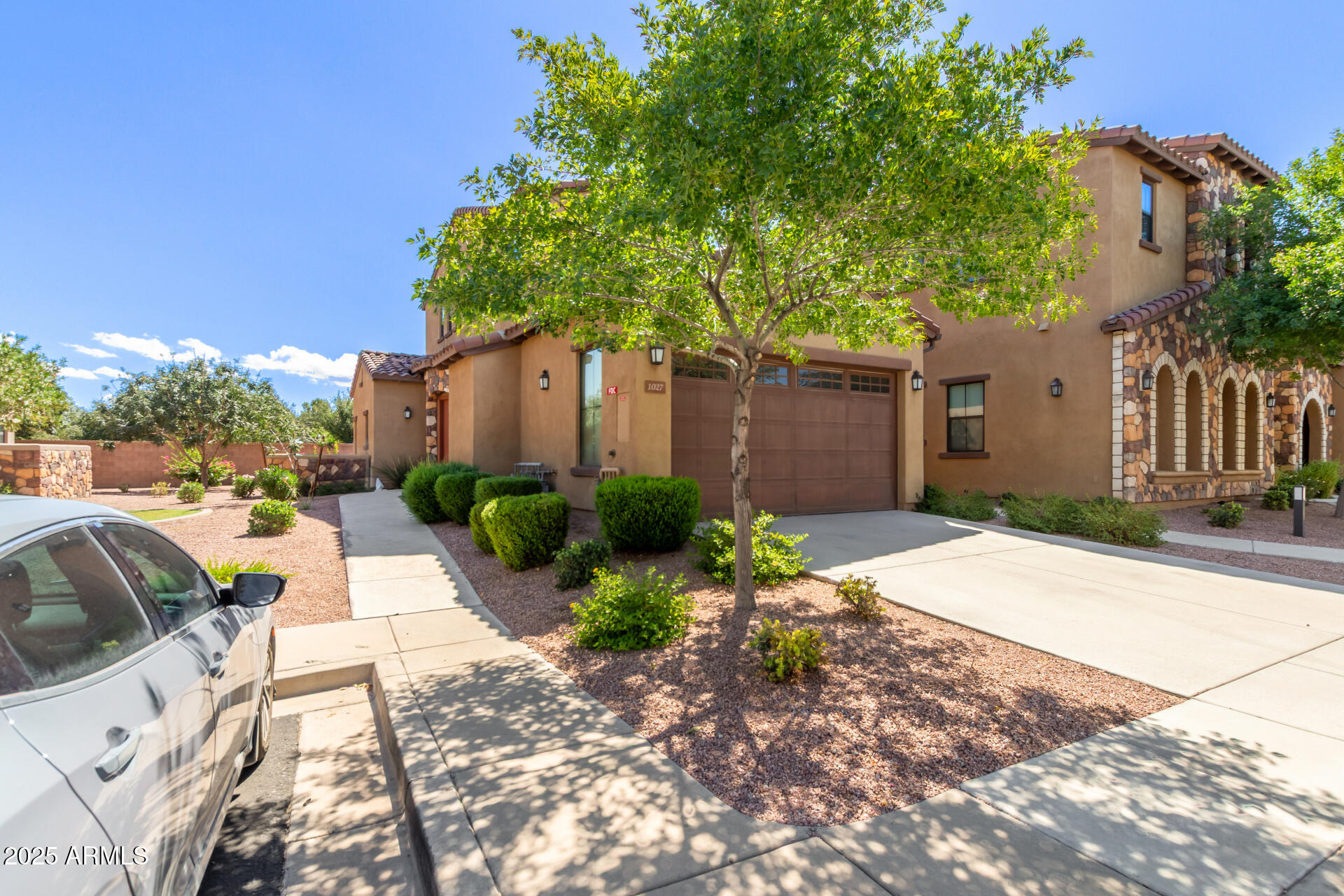 4777 South Fulton Ranch Boulevard, Unit 1027 Chandler, AZ 85248 - Photo 4 of 50 a front view of a house with garden