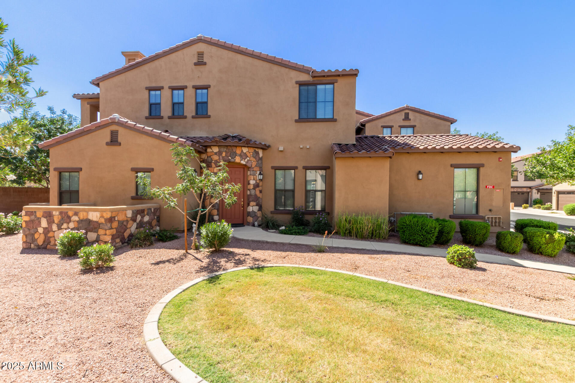 4777 South Fulton Ranch Boulevard, Unit 1027 Chandler, AZ 85248 - Photo 5 of 50 a front view of a house with a yard