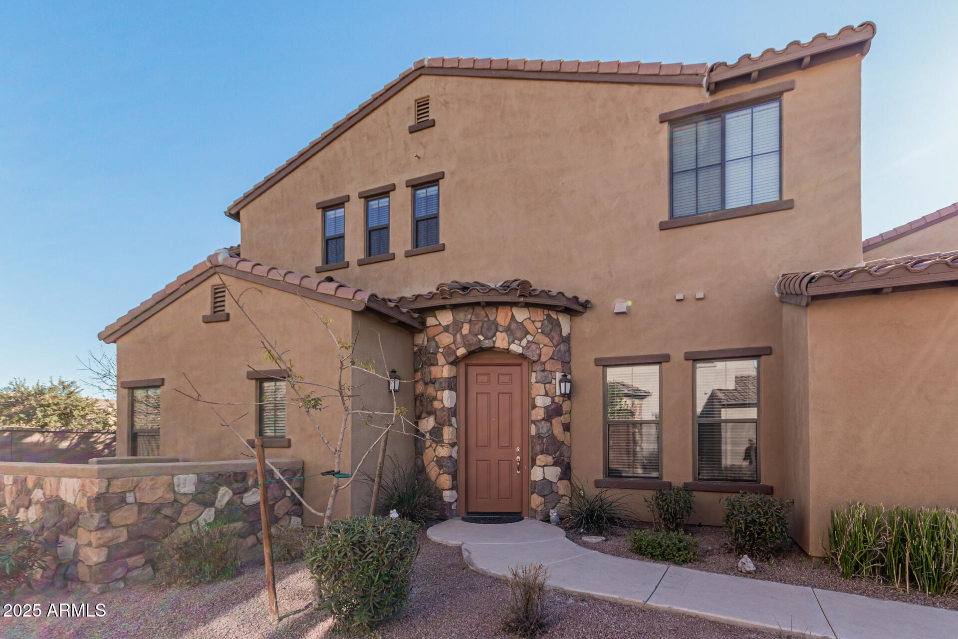 4777 South Fulton Ranch Boulevard, Unit 1027 Chandler, AZ 85248 - Photo 6 of 50 a front view of a house with garden