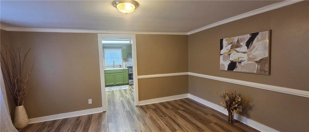 7043 South Goddard Road Stonecrest, GA 30038 - Photo 11 of 33 a view of an empty room with wooden floor and a window