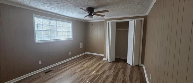 a view of a room with wooden floor and a window