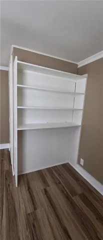 a view of storage and utility room with wooden floor