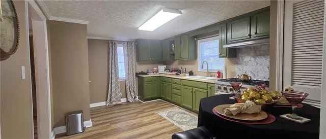 a kitchen with a sink stove and cabinets
