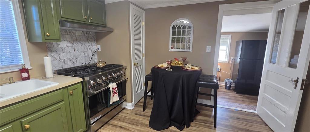 7043 South Goddard Road Stonecrest, GA 30038 - Photo 21 of 33 a kitchen with a sink stove and refrigerator