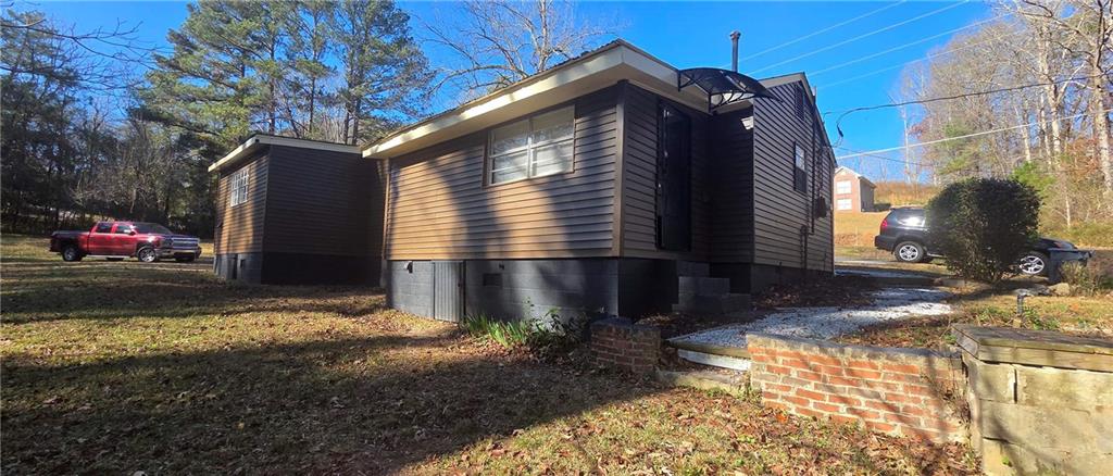 7043 South Goddard Road Stonecrest, GA 30038 - Photo 29 of 33 a view of a house with a yard