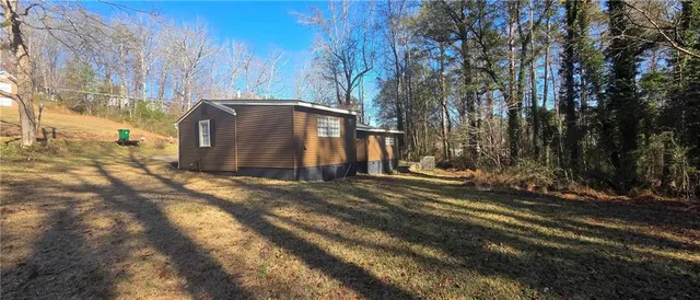 a view of a yard with large trees