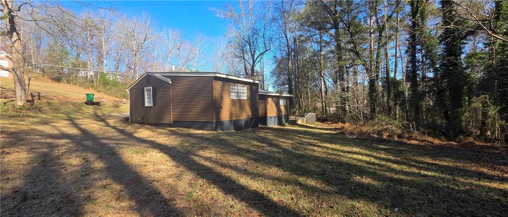 7043 South Goddard Road Stonecrest, GA 30038 - Photo 30 of 33 a view of a barn in the middle of a yard
