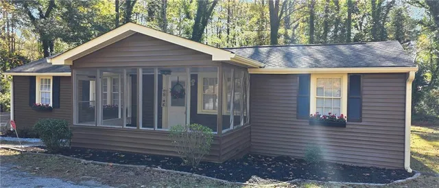 a front view of a house with a garden