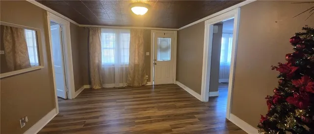 a view of a hallway with wooden floor and flower pot