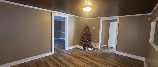 a view of a room with wooden floor and stairs