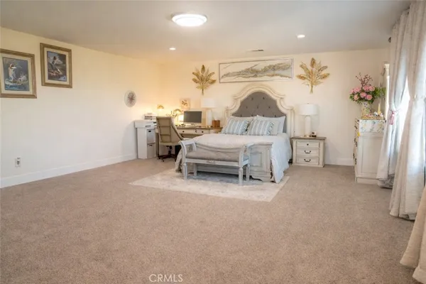 a spacious bedroom with a bed and a window