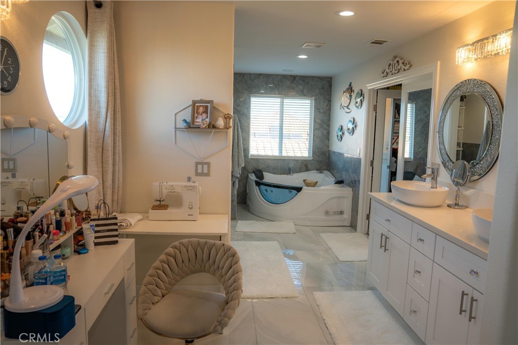 14464 Dove Canyon Drive Riverside, CA 92503 - Photo 12 of 25 a spacious bathroom with a granite countertop tub and a mirror