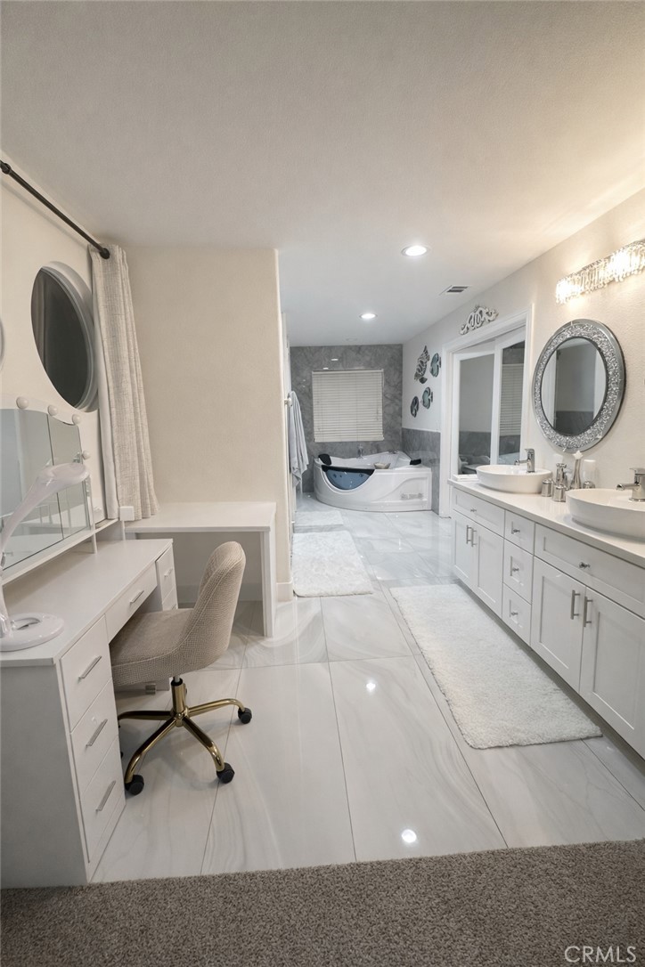 14464 Dove Canyon Drive Riverside, CA 92503 - Photo 13 of 25 a bathroom with a sink a toilet and a mirror