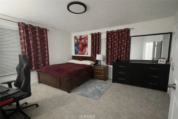 a bedroom with a bed and a dresser