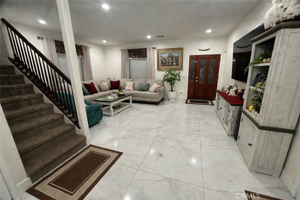 14464 Dove Canyon Drive Riverside, CA 92503 - Photo 4 of 25 a living room with furniture a flat screen tv and a refrigerator