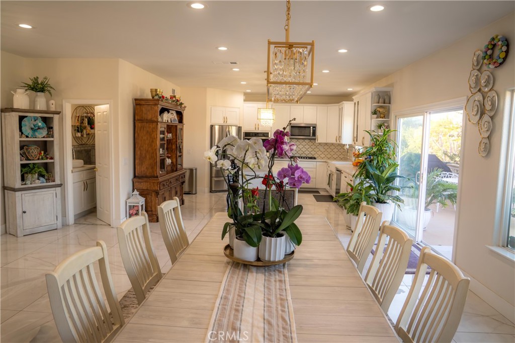 14464 Dove Canyon Drive Riverside, CA 92503 - Photo 7 of 25 a hallway with wooden table and chairs