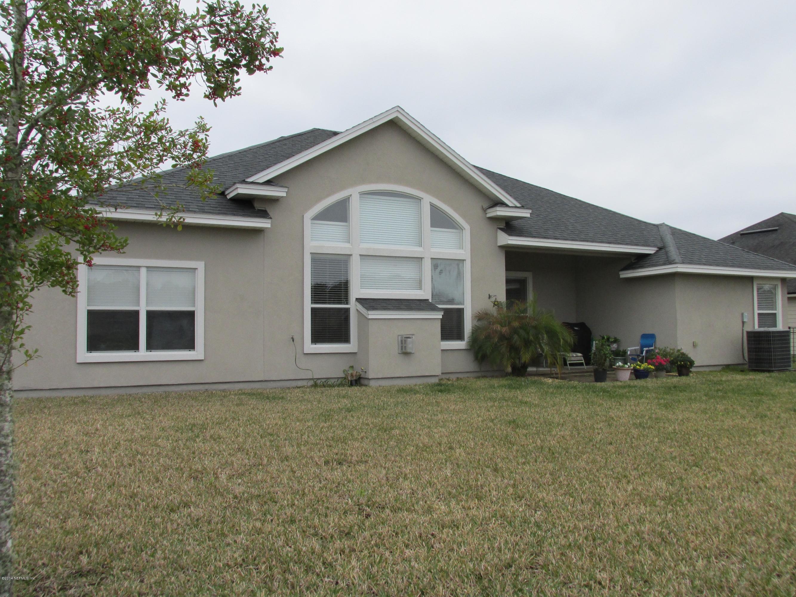 302 Porta Rosa Circle St. Augustine, FL 32092 - Photo 4 of 29 a front view of a house with a yard and garage