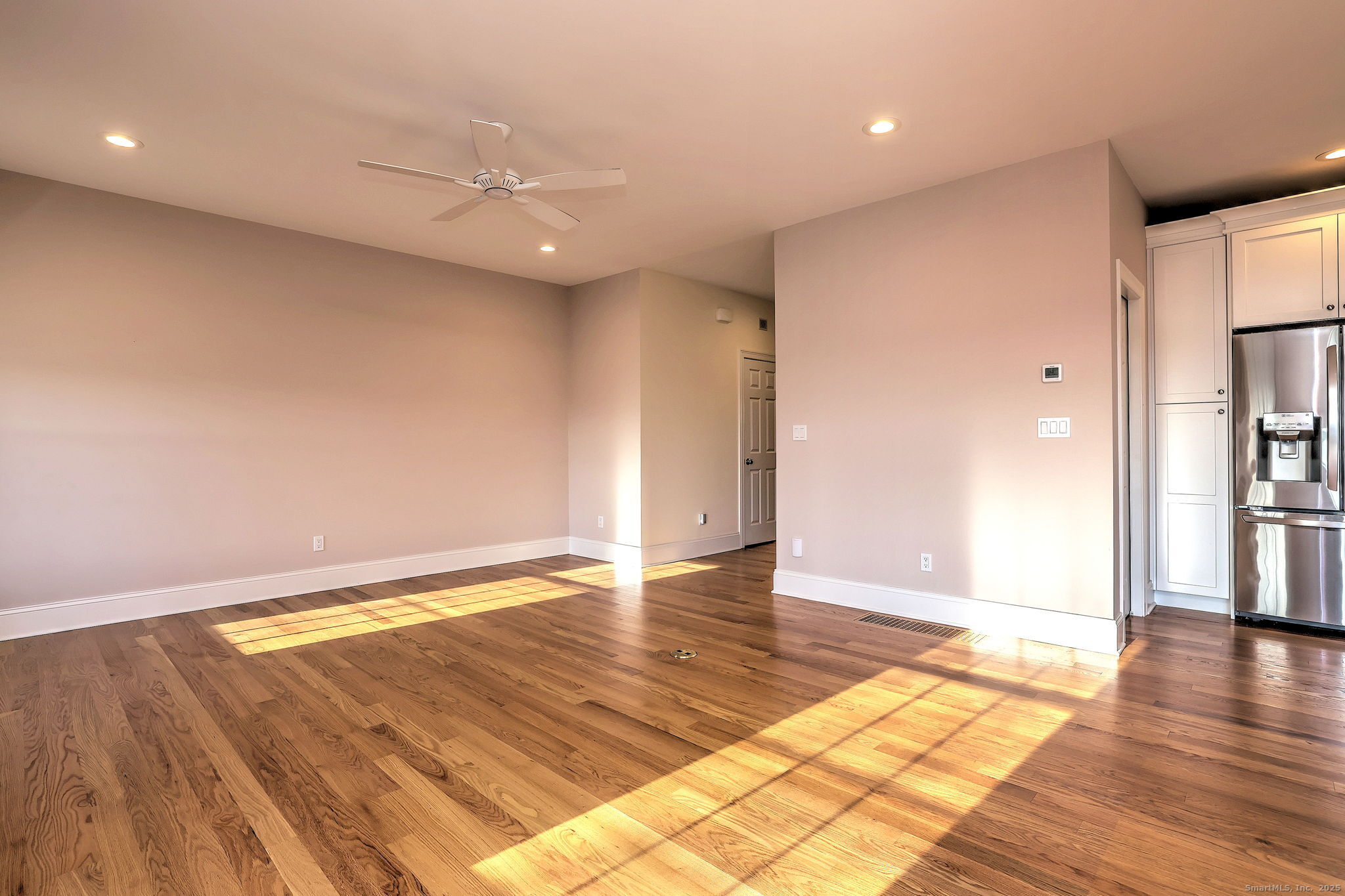 126 Wells View Road, Unit 126 Shelton, CT 06484 - Photo 11 of 26 a view of an empty room with wooden floor