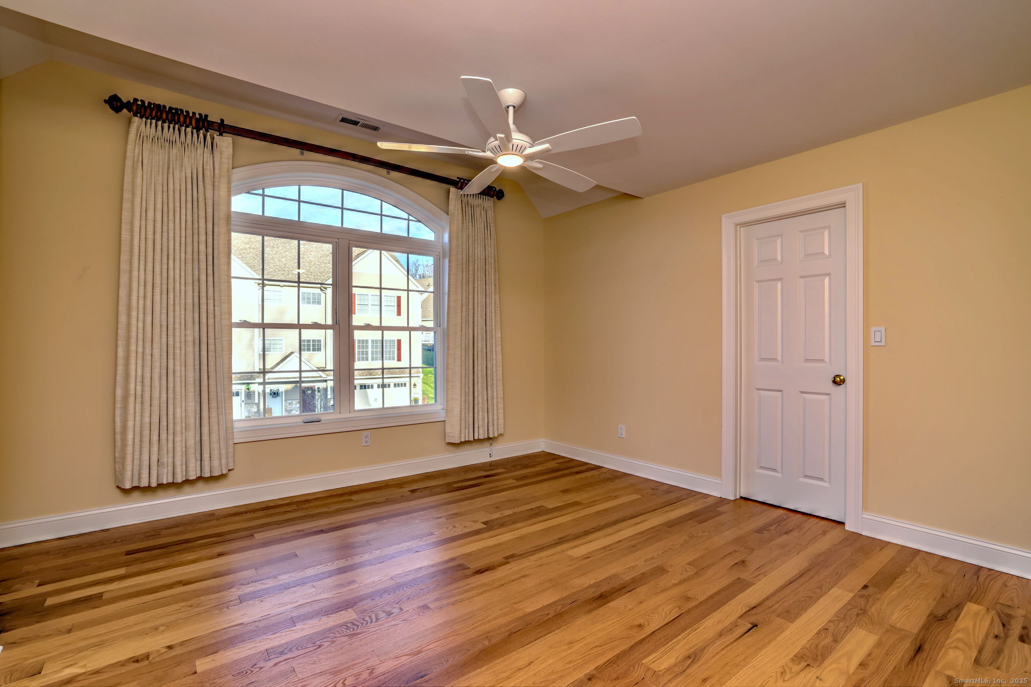 126 Wells View Road, Unit 126 Shelton, CT 06484 - Photo 21 of 26 a view of an empty room with wooden floor and a window