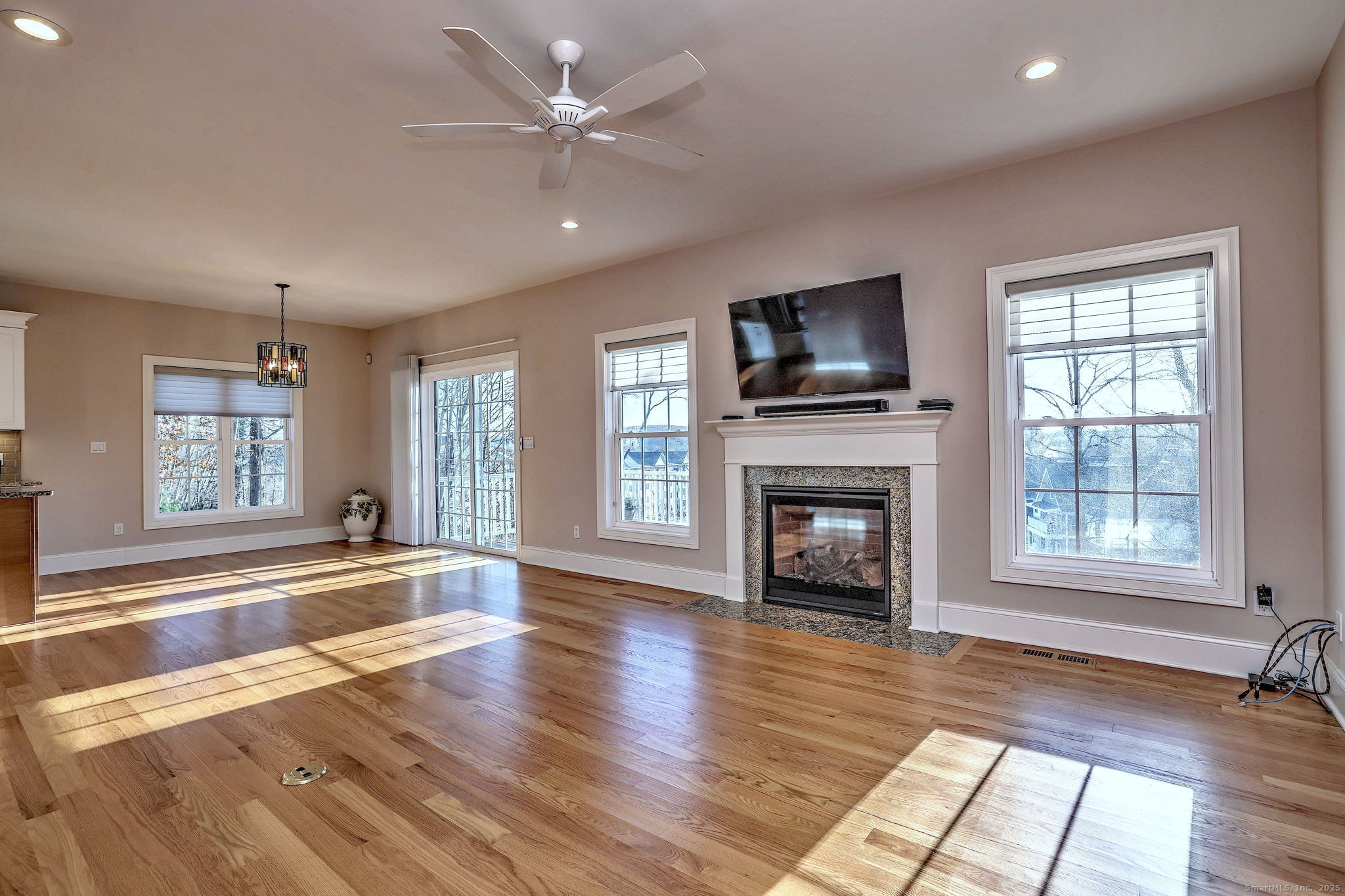 126 Wells View Road, Unit 126 Shelton, CT 06484 - Photo 9 of 26 wooden floor fireplace and windows in an empty room